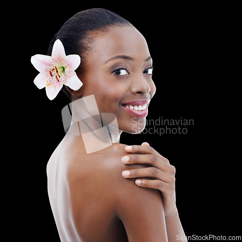 Image of Woman, portrait and orchid with beauty in studio for organic skincare, natural cosmetics or facial glow. Model, african person or face with smile, flower or self care for wellness on black background