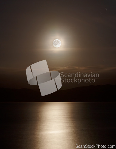 Image of Ocean, night and full moon on water for natural light, silver and seascape for low tide in nature. Dark sky, moonshine and lunar cycle for animal reproduction or stargazing and gravity pull on earth