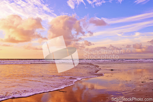 Image of Ocean, sunset and sand with waves on tropical island and tourism destination for summer vacation in nature. Blue sky, clouds or neon color on torrey pines beach, foam or outdoor travel in california