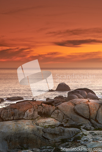 Image of Ocean, sunset and waves on rocks on tropical island and tourism destination for summer vacation in nature. Sky, clouds and golden color on torrey pines beach, peace and outdoor travel in california