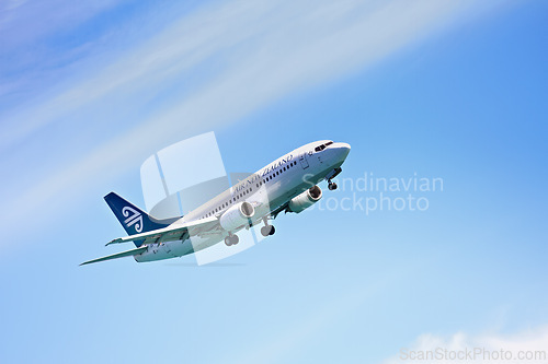 Image of Airplane, flying and blue sky for travel, holiday and vacation or immigration opportunity with New Zealand airline. Plane, aircraft and transportation in air or outdoors for an international flight