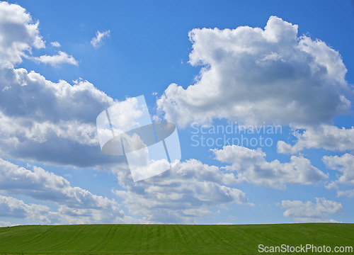 Image of Blue sky, clouds and landscape at countryside with environment, sustainability and summer sunshine. Nature, beauty and field with grass for eco friendly, growth and horizon with lawn on earth