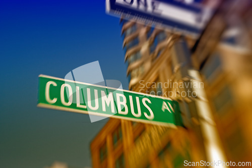 Image of Street sign, pole and city with building for travel location for navigation, directions or New York. Road, architecture and holiday adventure in America for exploring or blurred, downtown or urban