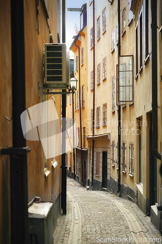 Image of Travel, architecture and alley in vintage city with history, culture or holiday destination in Sweden. Vacation, old buildings and antique stone street in Stockholm with cobble path in ancient town