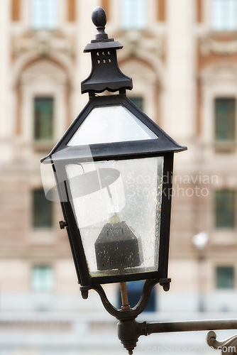 Image of Travel, architecture and lamp on vintage wall in old town with history, culture or holiday destination in Sweden. Vacation, landmark and antique lantern in Stockholm with retro light ancient city