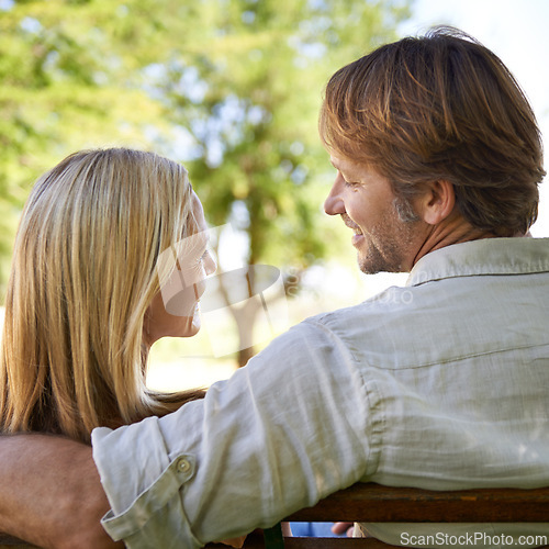 Image of Couple, back and bonding on bench, love and connection in relationship or security in outdoors. Mature people, laugh and date in nature or romance in garden, travel and vacation or support on holiday