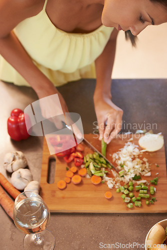 Image of Chef, food and health with woman in kitchen of home to prepare meal for diet or nutrition from above. Cooking, nutritionist or vegan and person cutting green vegetables with knife in apartment
