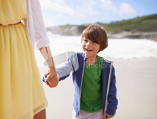 Image of Walking, kid and mother on the beach holding hands in summer, holiday or vacation with happiness in Florida. Happy, child and mom relax on sand together at ocean or sea for adventure in Miami