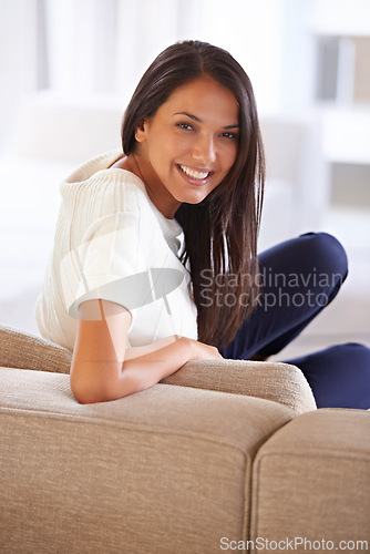 Image of Portrait, smile and wellness with woman on sofa in living room of home for free time, leisure or weekend. Relax, break and chilling with happy young person alone on comfortable couch in apartment