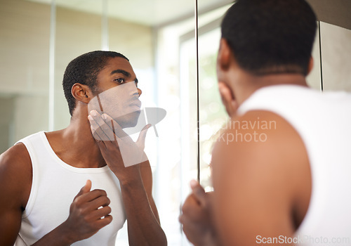 Image of Bathroom, mirror and black man grooming for skincare, self care and treatment for face of adult. African male person, morning and health with dermatology for results of soft, shave and glow of skin