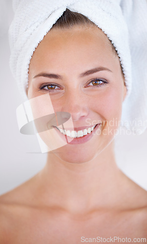 Image of Woman, face and smile with towel for skincare, dermatology, and cosmetic treatment for beauty. Model, happy person and clear skin for hygiene and cleanse for natural and fresh with bright smile