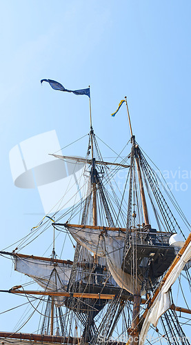 Image of Sailing, ship and mast outdoor with flag for travel, journey and adventure by blue sky in summer. Boat, wood pole and vintage schooner vessel on a cruise, rigging and transport with rope on mockup