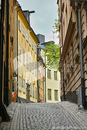 Image of Travel, architecture and road in vintage alley with history, culture or holiday destination in Sweden. Vacation, old buildings and antique stone street in Stockholm with cobble path in ancient city