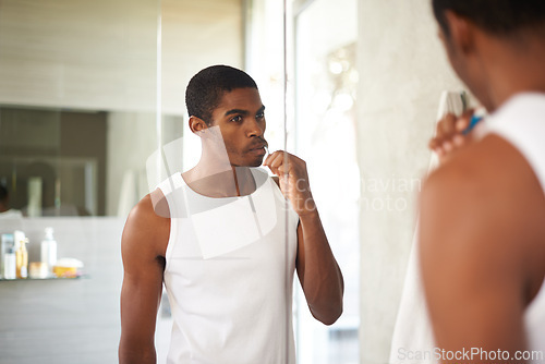 Image of Bathroom, black man and brushing teeth for oral hygiene, grooming and toothbrush for cleaning. Male person, self care and morning for whitening of tooth, health and fresh breath from mouth for guy