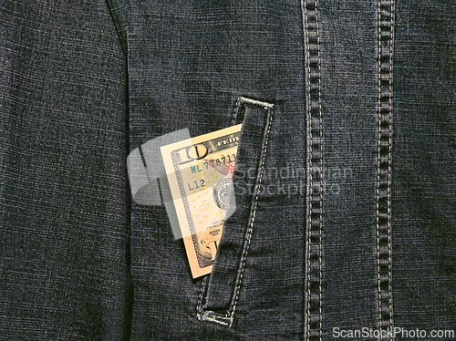 Image of Ten american dollars in a pocket of a denim jacket