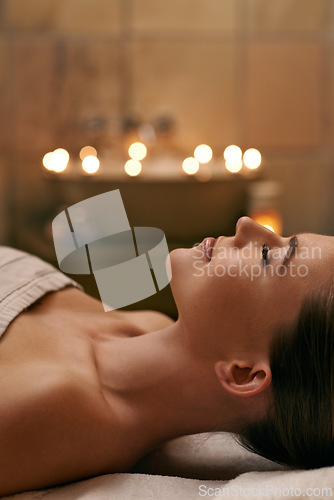 Image of Woman, spa and candle with luxury, calm and peace with wellness and bokeh. Person, skincare and health for zen, relax and body care at resort or massage parlour and serene rest and treatment