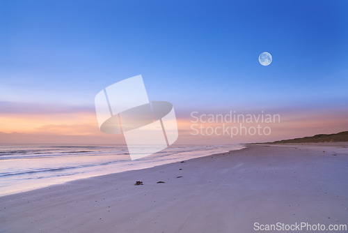 Image of Beach, blue sky and ocean, landscape with nature and environment, moon and sand with travel destination. Horizon, waves and seascape with natural background, tropical location or island for holiday