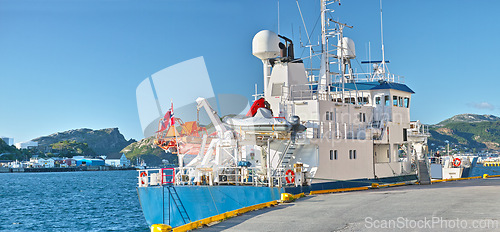 Image of Ship, water and harbor at sea to coast guard with landscape, blue sky and transportation for emergency sailing. Vessel, dock and ocean with yacht for maritime, danger and patrol in morning and nature