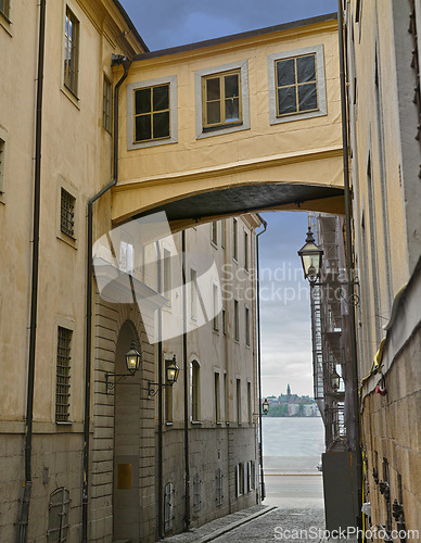 Image of Skybridge, architecture and city with vintage building in old town with history, culture and calm holiday destination. Vacation, travel or quiet alley in Sweden with retro aesthetic in ancient street