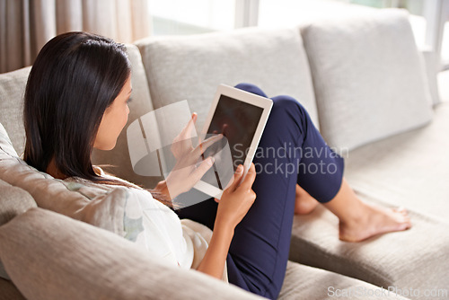 Image of Woman, relax and laptop for technology, sofa and lounge to connect to ebook and scroll social media. Female person, inside and couch in living room, leisure at home and online for research network