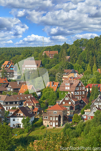 Image of Houses, trees in village or countryside landscape, travel and adventure location with hill, nature and buildings. Neighborhood, real estate and property with architecture for holiday in Germany