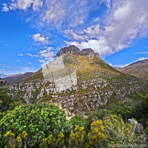 Image of Mountains, summer and blue sky with nature, clouds or stone with landscape or plants with sunshine. Empty, outdoor or grass with flowers or countryside with adventure or travel with vacation or earth