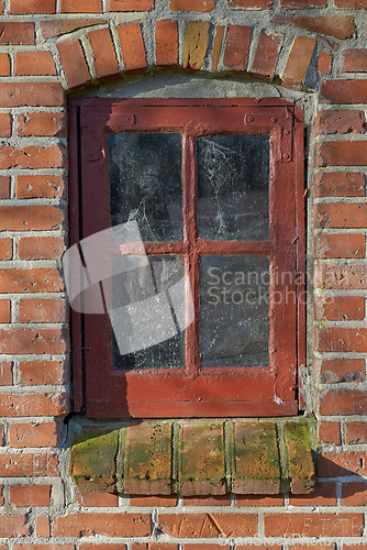 Image of Old, window and exterior with brick wall of rustic wooden frame, abandoned house or building. Glass of historic outdoor home with vintage or rubble of damage, neglect or aged texture in dirt or dust