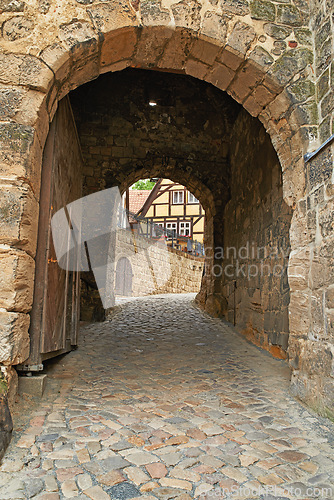 Image of Arch, path and brick wall with tunnel of ancient passageway, building pattern or exterior architecture. Empty route, concrete trail or historic landmark of secret hallway or hidden outdoor corridor