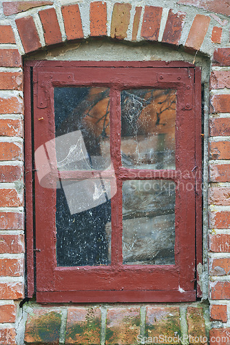 Image of Old, window and exterior with brick wall of abandoned house, building or wooden frame. Glass of historic outdoor home with vintage or rustic rubble of damage, neglect or aged texture in dirt or dust