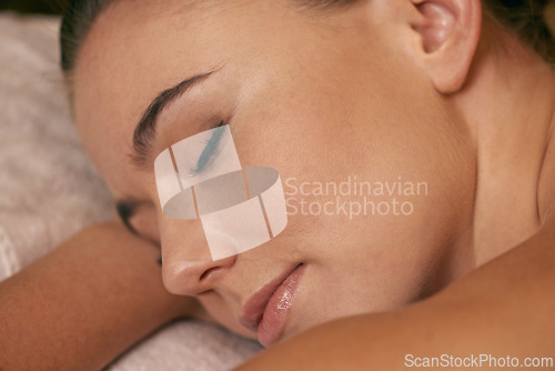 Image of Woman, lying and relax in spa for peace or wellness, sleeping or daydreaming and calm to free tension. Female person, closeup and luxury for stress relief or rest for wellbeing with aromatherapy.