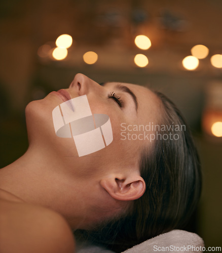 Image of Woman, spa and candle with luxury, relax and peace with wellness and bokeh. Person, skincare and health for zen, calm and body care at resort or massage parlour and serene ambience and treatment