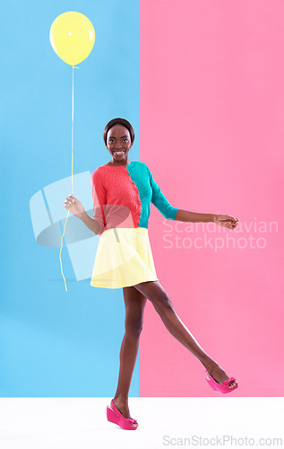 Image of Woman, balloon and smile with colorful clothes for fashion, trendy and playful for outstanding and bold style. African person, model and happy lady for funky look, retro or different for fun