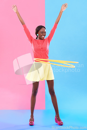 Image of Woman, smile and hand up for victory, dance and hoop for success on color block background. Winner, female person and spinning of plastic toy to celebrate, achievement or good news in studio