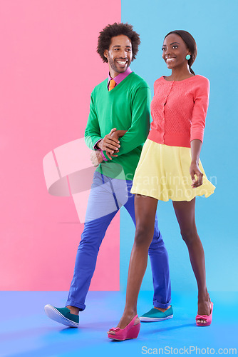 Image of Couple, walk and happy with fashion in studio, background and creative aesthetic. Excited, woman and man together with colorful retro style, unique clothes or person with support, love and trust