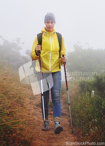 Image of Woman, hiking and trail in nature with fitness outdoor gear for travel, adventure and backpacking. Freedom, path and female person in trekking pole for wellness, exercise or balance in forest.