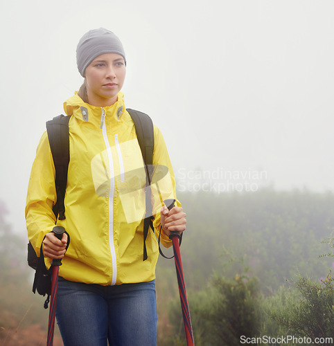 Image of Woman, trekking and fitness in nature with pole for backpacking, travel and outdoor adventure. Journey, path and female person in hiking gear for exercise, balance or health in forest trail.