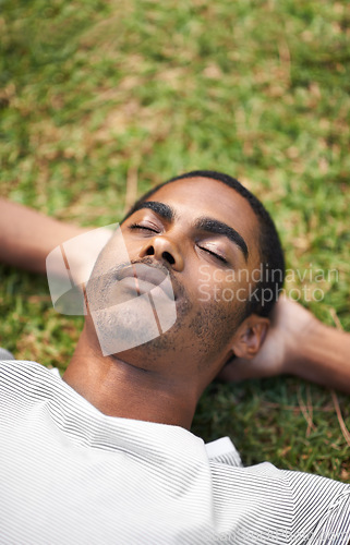 Image of Face, sleep and black man on grass in garden of summer home for peace, wellness or mindfulness. Nature, relax and filed with calm young person lying on green ground from above for break or rest