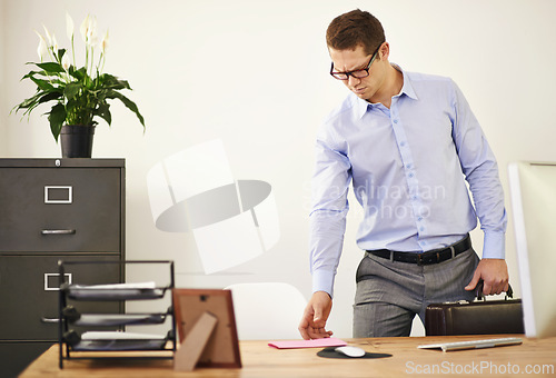 Image of Desk, letter and confused business man with briefcase in office looking worried for employment. Anxiety, doubt or frown and young employee with glasses in professional workplace for notification