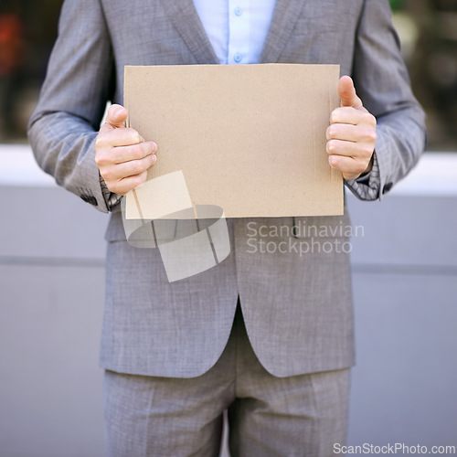 Image of Blank, cardboard and unemployment person with suit, poster and mockup for job hunting outdoor. Professional, hands and businessman sign to seek or search for work on street in city of Cape Town