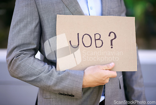 Image of Hand, businessman and board for unemployed, jobless and poverty for adult, search or hunting for work. Economy, poor and male person as accountant showing sign on street in city of Cape Town