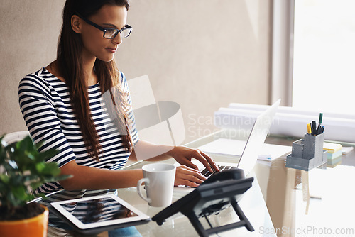 Image of Woman, desk and computer with blueprints for interior design or creative career, happy and working on graphics on laptop. Online, search and plan project with digital technology and information