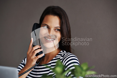 Image of Telephone call, happy and business woman in conversation, talking or listening to contact in startup office. Landline, smile and secretary on phone, receptionist and creative person with mockup space