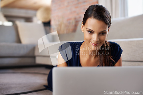 Image of Laptop, smile and young woman relaxing on carpet working on freelance project at home. Happy, technology and female person with computer for creative research laying on floor mat in living room.