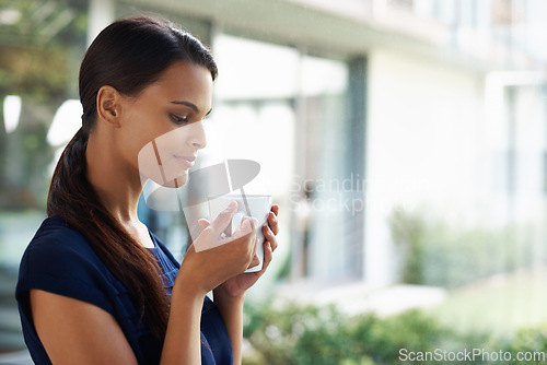 Image of Woman, thinking and drinking coffee in home to relax, peace or calm at breakfast for energy in the morning. Dream, tea cup or person with espresso, latte or hot healthy beverage for wellness in house