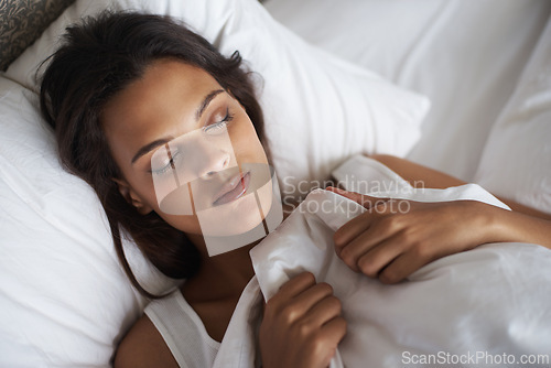 Image of Woman, sleeping and bed for peaceful, dream and wellbeing as stress relief in bedroom in Toronto. Mental health, female person and eyes closed on pillow for calm, sleep and rest for self care in home