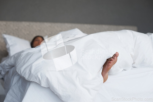 Image of Lazy, feet and woman in bedroom sleeping, house and white duvet for bedding, nap and exhausted. Morning, dream and female person on day off to relax in apartment, rest and cosy with blanket on bed