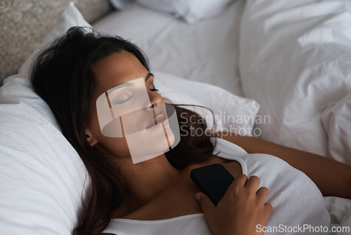 Image of Night, sleep and woman on bed with phone waiting for call, tired and fatigue for girl in home. Female person, peace and relax in bedroom with mobile for communication, contact and app to connect