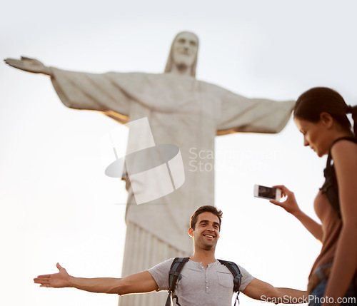 Image of Tourist, happy and photograph with monument for sightseeing, freedom and christ the redeemer statue in Rio de Janeiro with girlfriend. Couple, explore and holiday for adventure or tour with cellphone