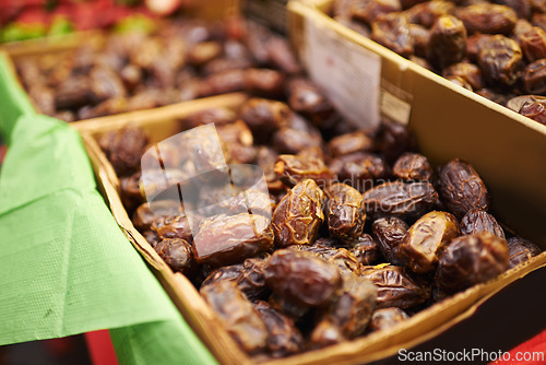 Image of Harvest, natural and bunch of organic dates for nutrition, health and wellness diet snack. Sustainable, farmers market and dried fruit for vitamins, digestion or fiber on display in grocery store.