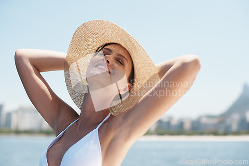 Image of Woman, smile and hat on vacation, holiday and tour outdoor by cityscape, seascape and skyline. Happy female person, tourist and model on yacht in ocean, beach or summer for travel, tourism or leisure